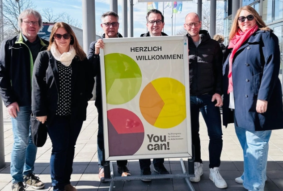 sechst Personen neben dem Schild "You Can - Fachkongress für Inklusion im Arbeitsleben"